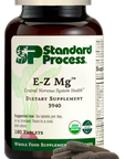 Image of E-Z Mg bottle next to tablets of magnesium supplements.