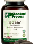 Image of E-Z Mg bottle next to tablets of magnesium supplements.